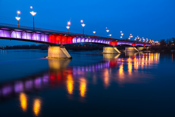 Night view on the Slasko-Dabrowski bridge over the Vistula river, Warsaw, Poland