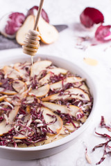 Focaccia with red radicchio, taleggio cheese and pears topped with a drizzle of honey. Traditional Italian recipe.