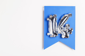 Number 14 silver balloon celebration number on a blue banner