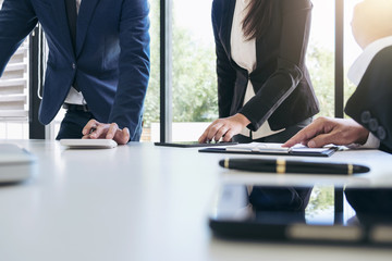 Teamwork process, Business team managers colleagues discussing and analysis new plan financial graph data and marketing documents report on office table with laptop and digital tablet