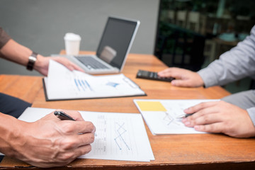 Two confident executives business colleagues meeting and discussing ideas of project about company offer, they is pointing on a contract and giving explanations, team of successful business people