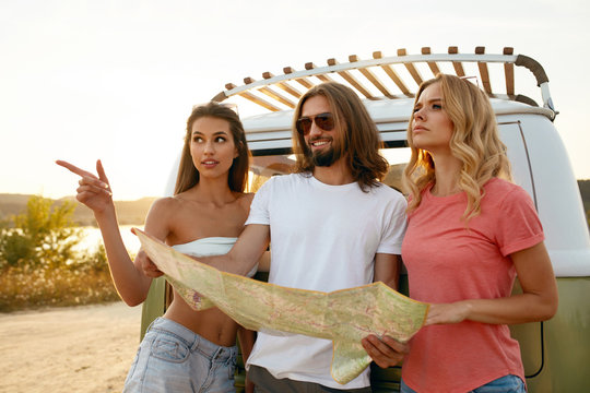 People Using Map Traveling In Summer.