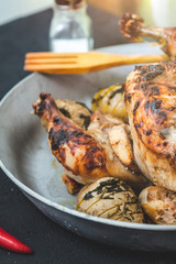 fried chicken with baked potatoes in a frying pan. Menu, restaurant and recipe concept