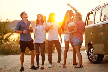 Obraz premium Young Friends Dancing And Drinking In Nature.