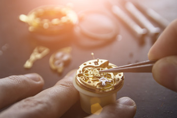The watchmaker is repairing the mechanical watches, gears