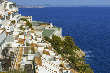 a fragment of typical architecture of the resort area of the Spanish town of Magaluf on the background of blue sea