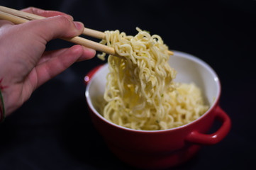 fast noodles on a black background