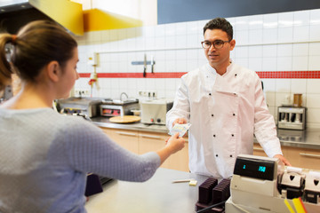 seller and customer paying at fast food restaurant