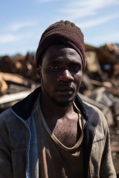 Worker looking at camera in the scrapyard