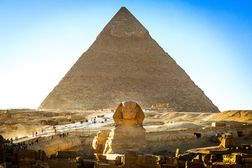Fototapeta na wymiar Egyptian sphinx with a ptramid in background