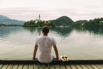 Tourist handsome man enjoying the view on the lake.