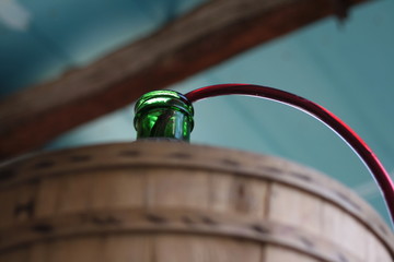 Siphoning wine into a demijohn, carboy. Wallpaper, background. With copy space.