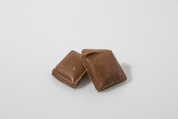 Dark chocolate in a white background composition