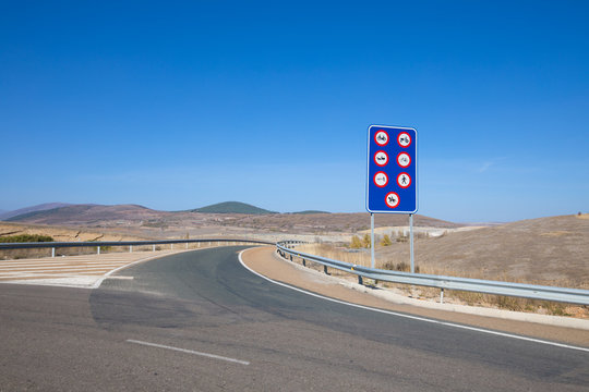 sign indicating prohibited vehicles (moped, tractor, caravan, bike, pedestrian, horse) on the highway in lonely road of Spain, Europe
