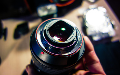 Fototapeta na wymiar Camera lens closeup with light reflection and blurred background