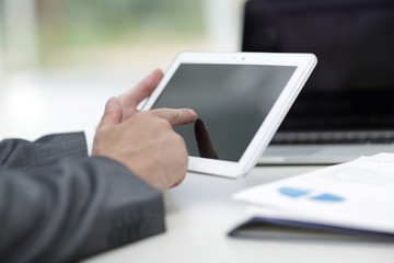 closeup.successful businessman working with tablet computer