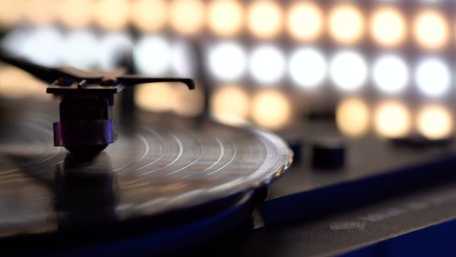 Vinyl disc turning on retro record player, close up