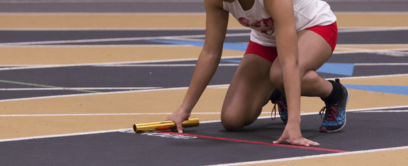 Track sprinter starting a relay race