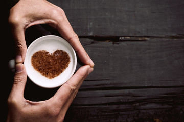 man with a cup of cappuccino with a heart