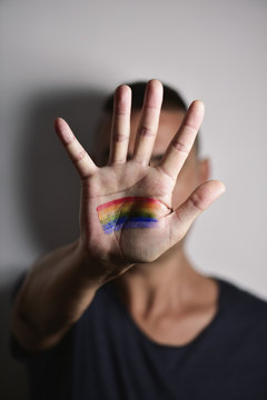 man with a rainbow flag in his hand