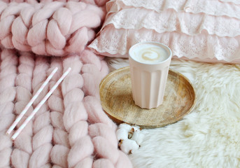 Cup with cappuccino, pink pastel giant plaid, fur, bedroom, morning concept