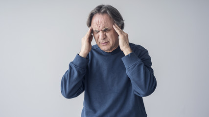 Elderly man having headache