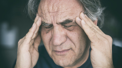 Elderly man having headache