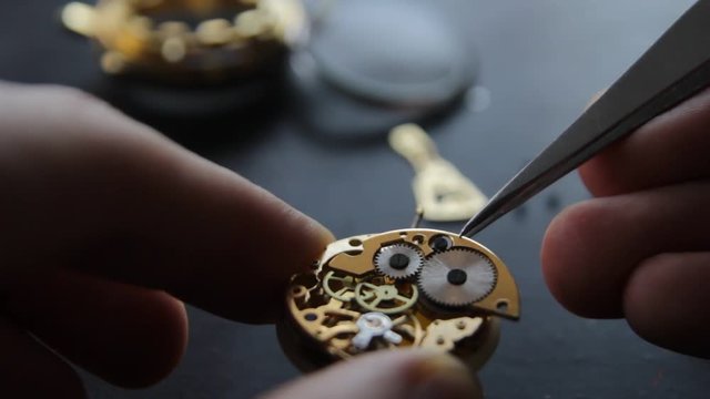 Watchmaker is repairing the mechanical watches in his workshop