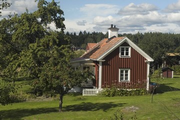  Swedish wooden hut painted in traditional falun red.