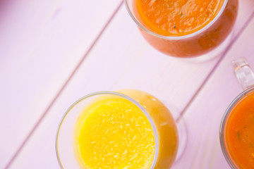 Fruit and Vegetable Smoothie, Healthy Food, Diet Concept. Pink wooden background with glasses of fruit and vegetable smoothie, copy space, top view