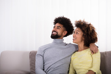 Obraz premium Couple Sitting On Sofa
