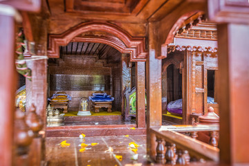 Beautiful Thai style spirit house or house of the guardian spirit is made of wood and sculptured wood. Thai houses ancient style pattern. Foreshorten.