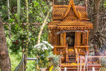 Beautiful Thai style spirit house or house of the guardian spirit is made of wood and sculptured...