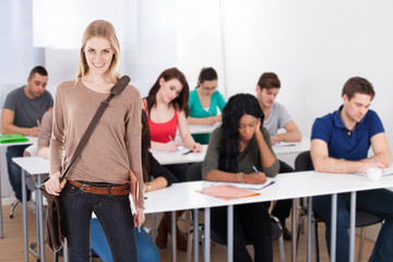 Confident Student Standing Against White Background