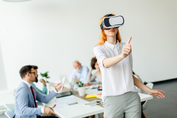 Young woman using virtual reality simulator in the office