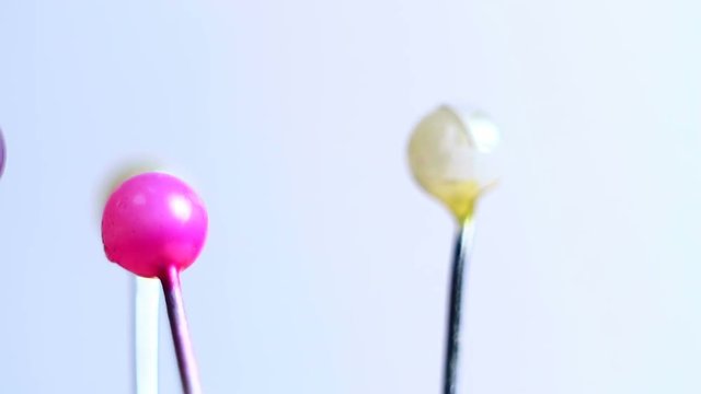 Tools tailor. Many multi-colored pins close-up. Shallow depth of field. Smooth rotation and impact.