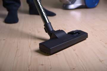 Man vacuums the floor