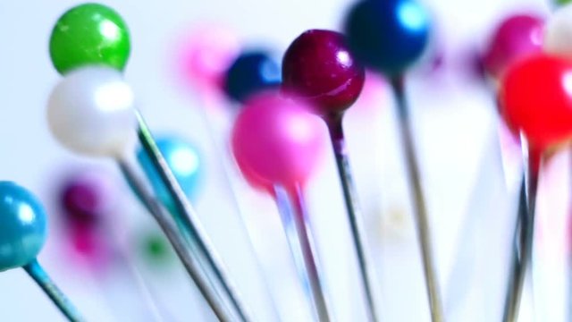 Tools tailor. Many multi-colored pins close-up. Shallow depth of field. Smooth rotation and impact.