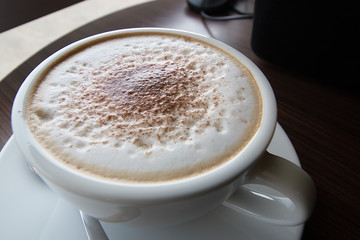 The cup of coffee.