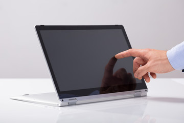 Businessman Touching His Finger On Hybrid Laptop Screen