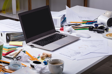 Open Laptop On The Messy Desk