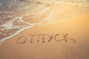 The inscription on the sand. Inscription on the bank of the ocean"vacation" in Russian language