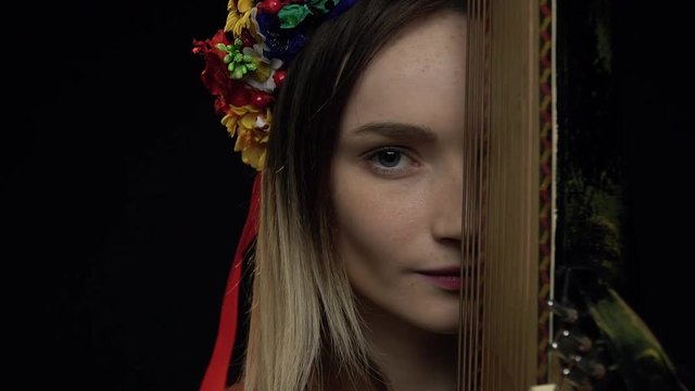 Ukrainian girl playfully looks at the camera near the pandora