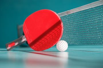 Red racket and a ball for table tennis