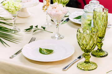 Festive table, decorated with vases, fruits and pastries.