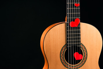 Obraz na płótnie Canvas Red hearts on the strings of a guitar