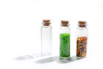 .Powder for Easter cake in glass bottles with cork cover on white background