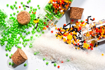 Decorative Powder for Easter cake in glass bottles on a white background