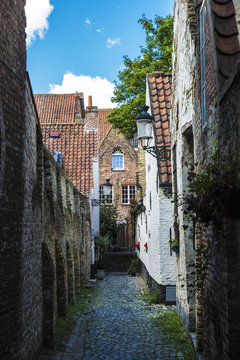 Narrow street with old houses in Bruges, Belgium