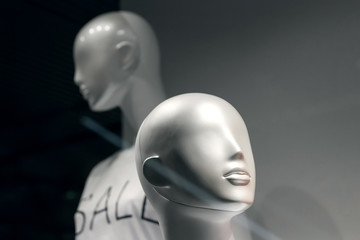 Heads of two mannequins on a black background